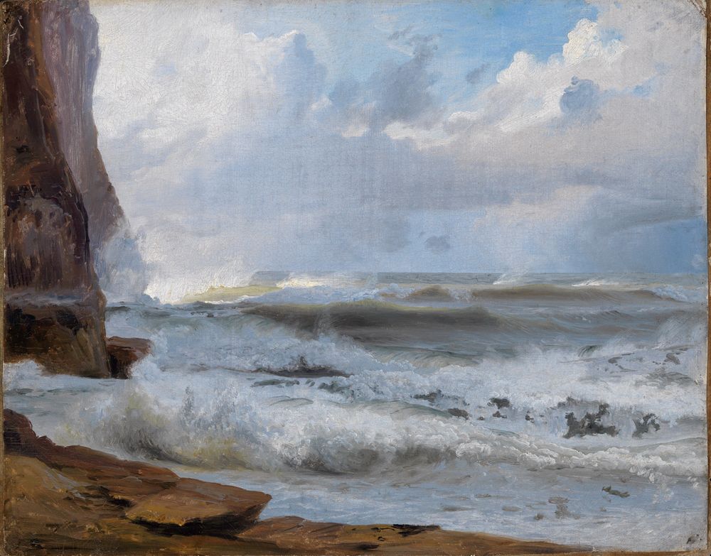 Das Ölgemälde von Johann Wilhelm Schirmer zeigt eine stürmische Küste. Vorne brechen hohe Wellen gegen schroffe, raue Felsen. Im Hintergrund erhebt sich eine große Klippe.