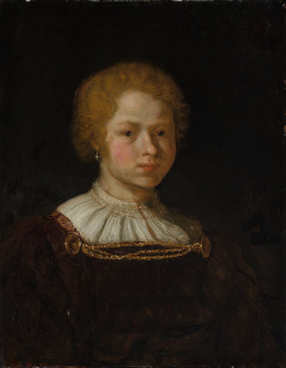 Das Bild von Rembrandt zeigt ein junges Mädchen. Sie trägt ein schlichtes, dunkles Kleid und hat eine helle, von Licht umspielte Haut. Ihr Haar ist einfach frisiert.
