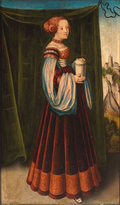 Das Gemälde von Lucas Cranach zeigt eine Frau in einem einfachen Kleid. Sie hält eine wertvolle Salbenschale in der Hand.