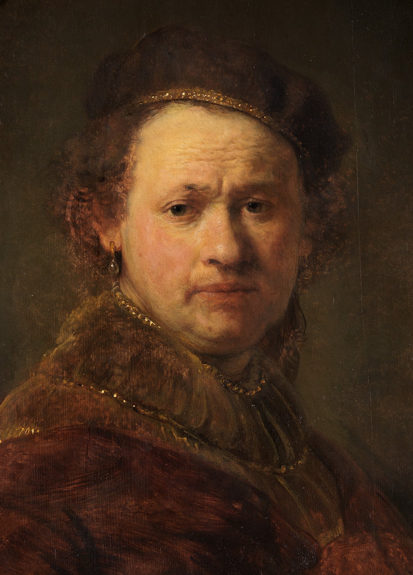 Abbildung des Selbstbildnis von Rembrandt. Er trägt einen Hut und einen braunen Umhang. Die Farbe braun bestimmt das Portrait.
