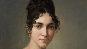Abbildung von Marie Ellenrieders Selbstbildnis. Zu sehen ist ihr Kopf. Sie trägt eine Ketter und Ohrringe. Ihre schwarzen Haare sind nach oben gesteckt.