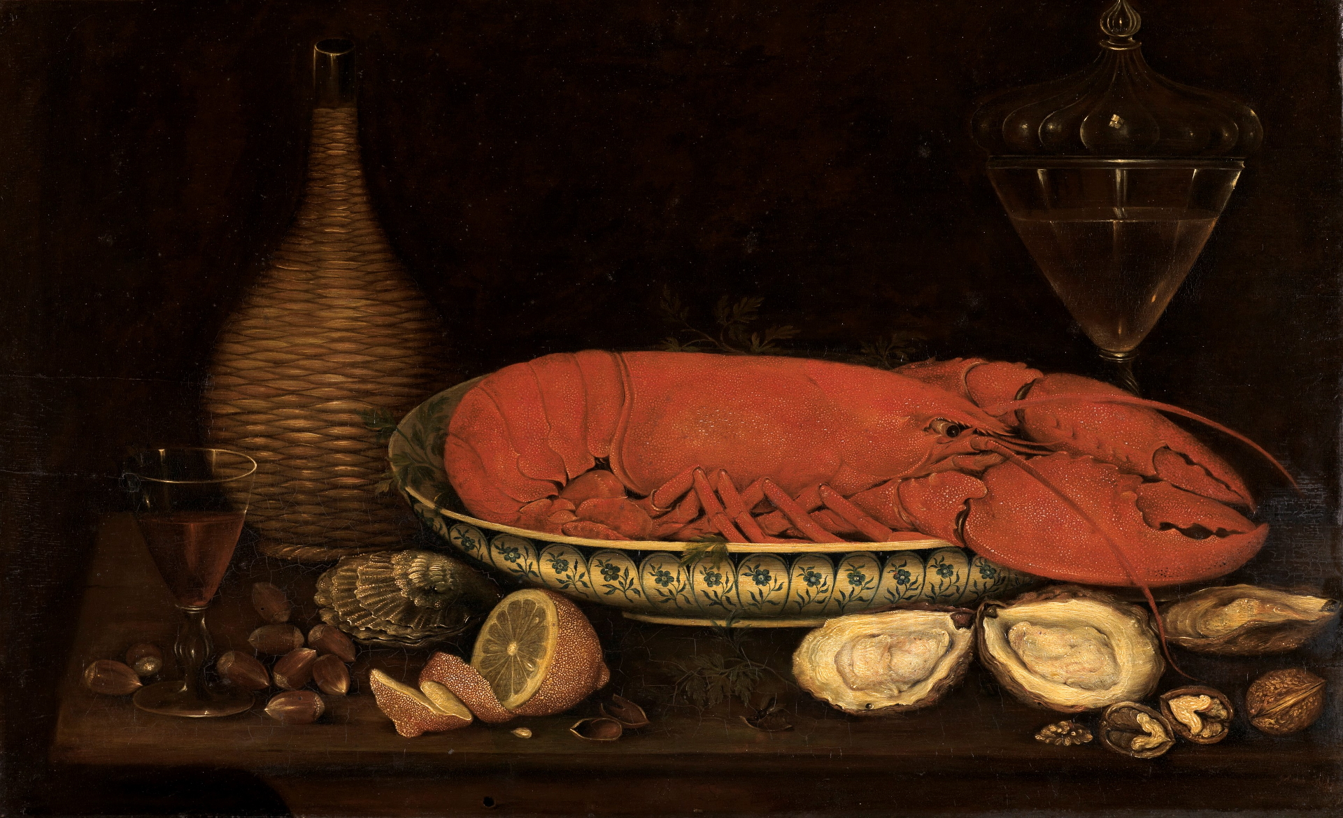 Frühstücksstillleben mit Hummer von Johann Seitz. Es zeigt eine Schale auf einem Tisch. In der Schale liegt ein Hummer. Darum stehen Gläser und Krüge.