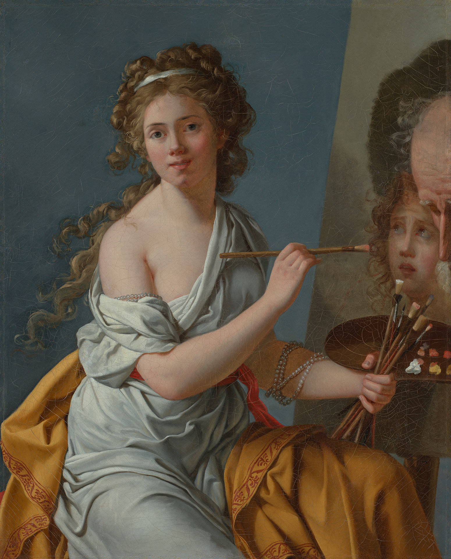 Abbildung des Selbstbildnisses von Marie-Guilhelmine Benoist, auf dem die Künstlerin mit lockigem Haar und wallender Kleidung in die Kamera blickt. Sie hält einen Pinsel in der Hand und sitzt vor einer Leinwand, auf der sie gerade an einem Gemälde arbeitet.
