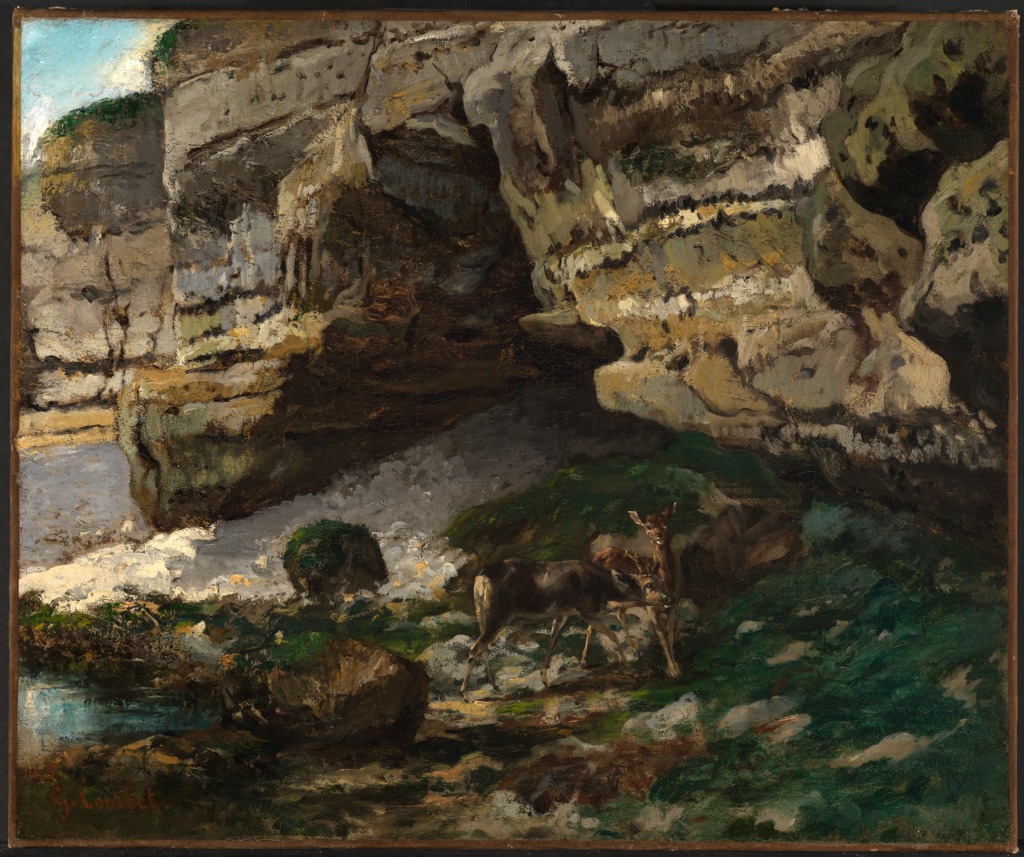 The painting by the artist Courbet shows a rocky landscape. Two deer can be seen at the foot of the rocks.
