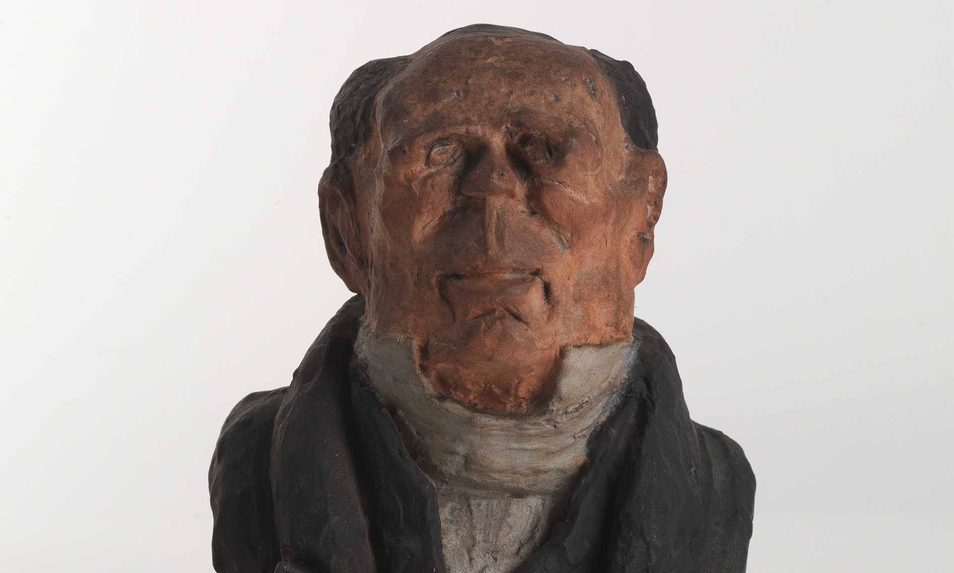 Z sehen ist eine Büste eines Mannes mit Glatze. Die Skulptur stammt von dem französischen Künstler und Bildhauer Honore Daumier.